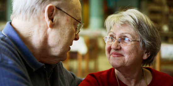 Older couple smiling at each other