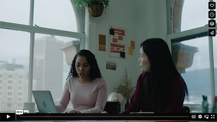 photo of two people working around a computer together